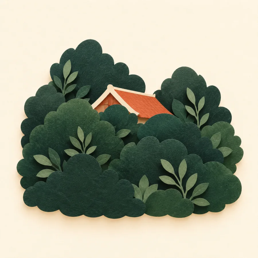 A small house almost hidden behind dense foliage