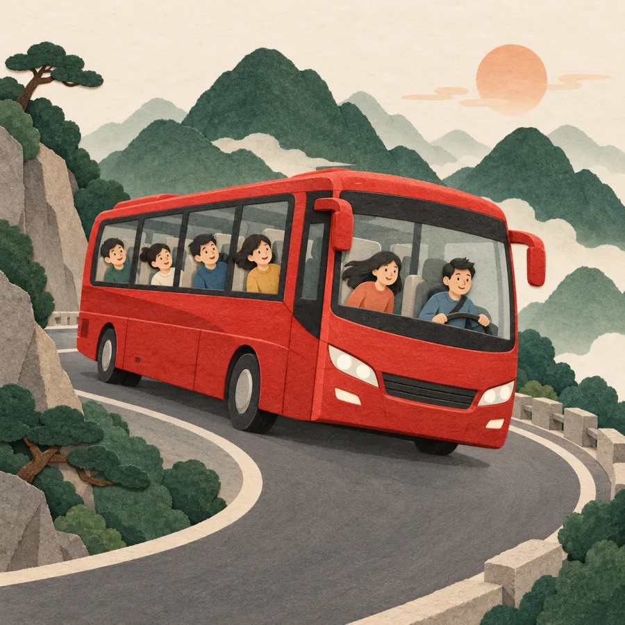 A bus leans around a sharp bend on a mountain road