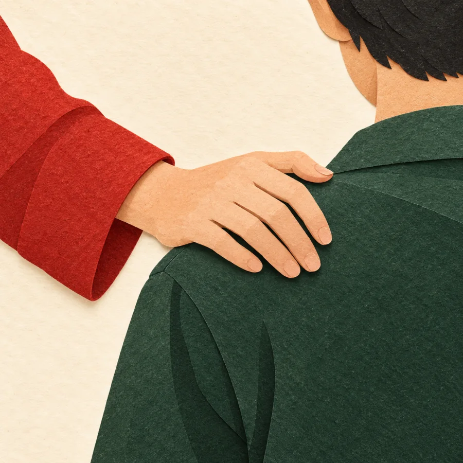 A friend's hand rests on a person's shoulder