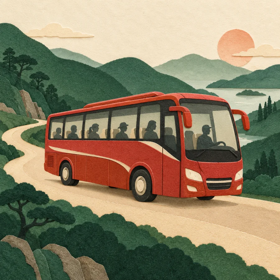 A red bus drives along a road among green hills