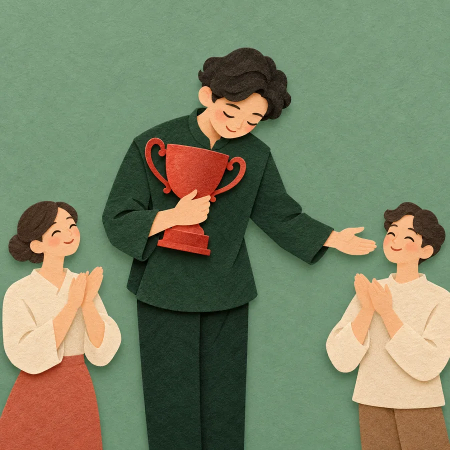 A person holding a trophy bows and gestures to others