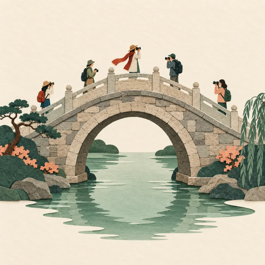 Tourists take photos of an old stone bridge