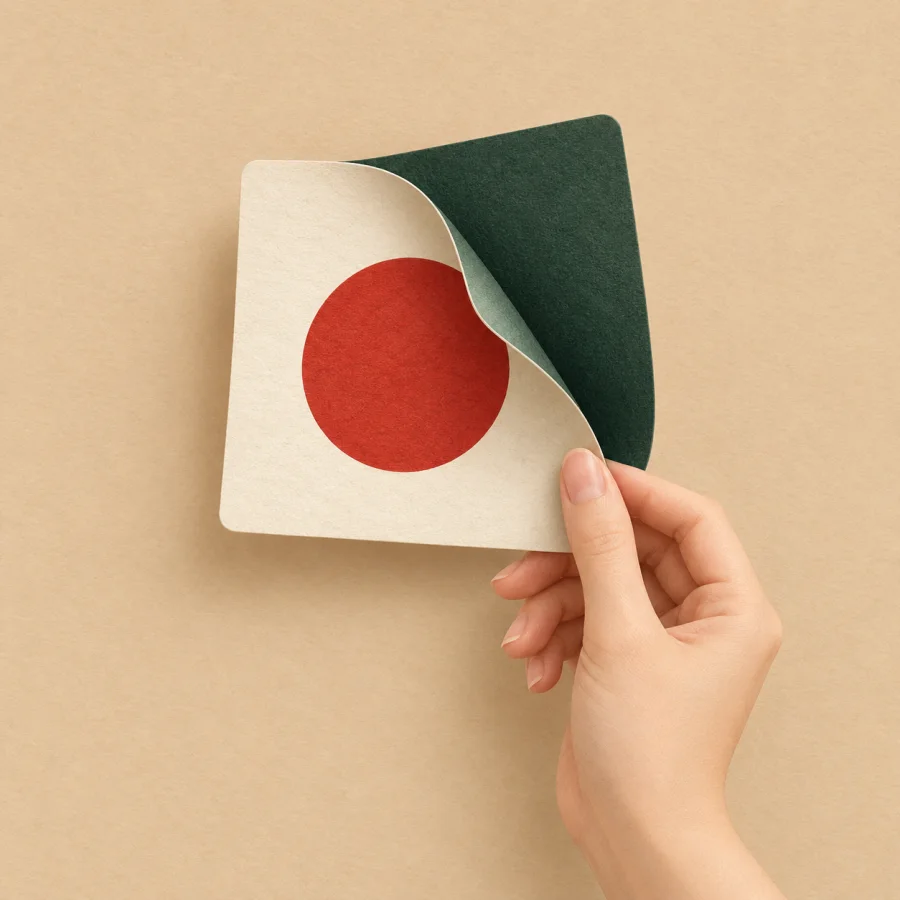 A hand flips over a square card