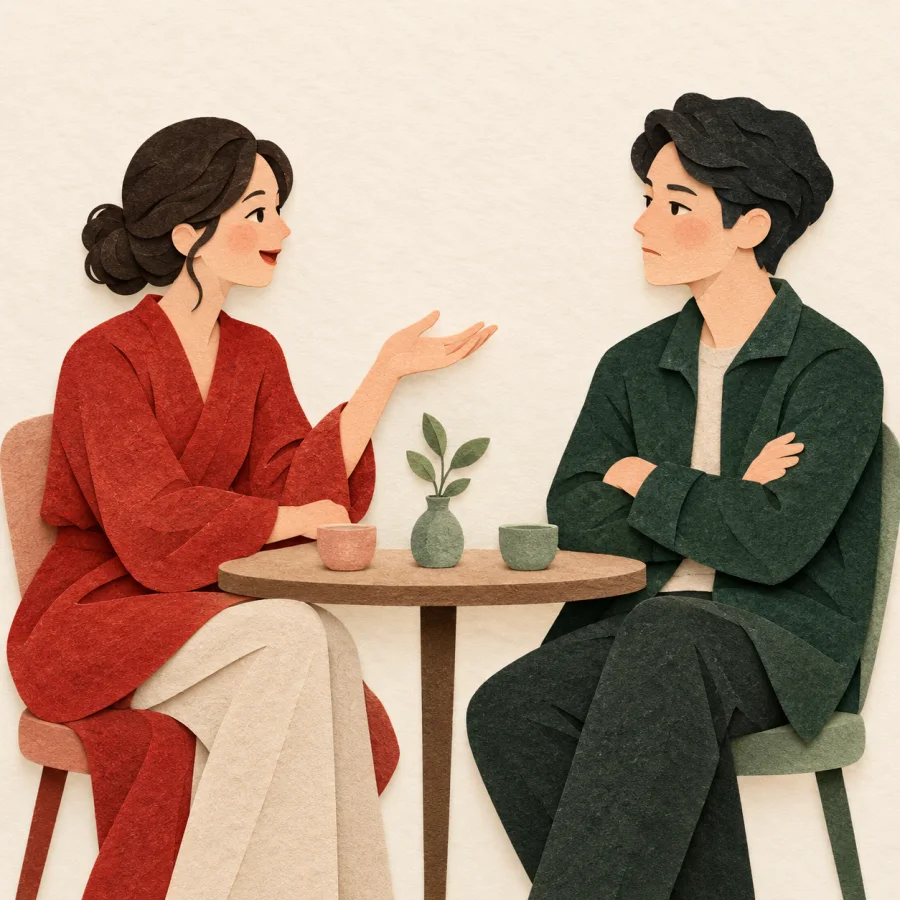 Two people at a table, one gesturing in a debate