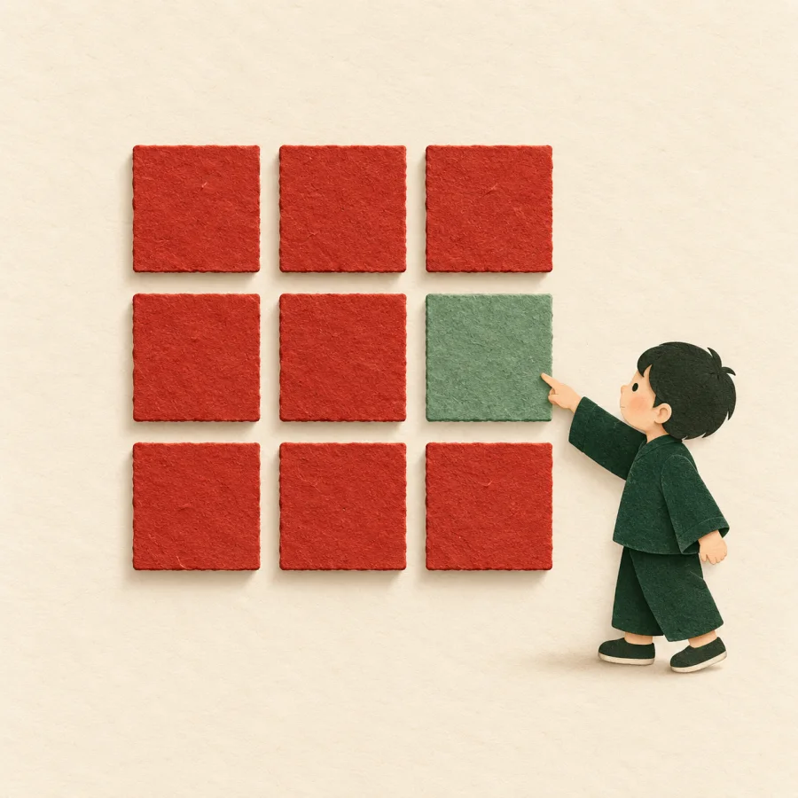 A person points at a block of the wrong colour in a row