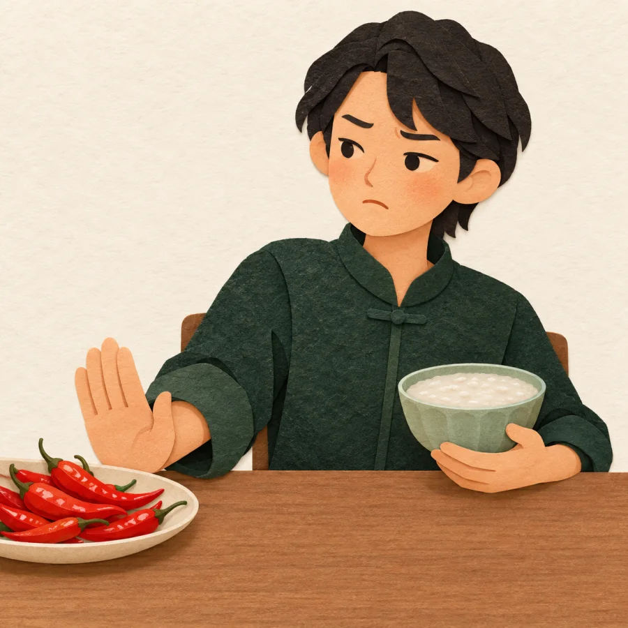 A person pushes away a plate of red chilies and takes plain porridge