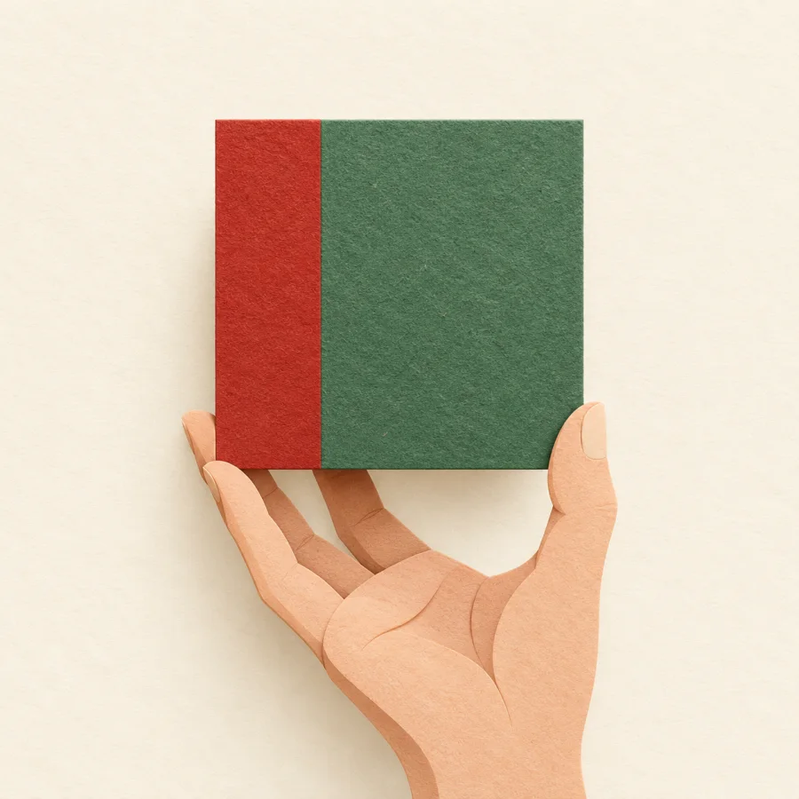 A hand holds a square made of a narrow red block and a wide green one