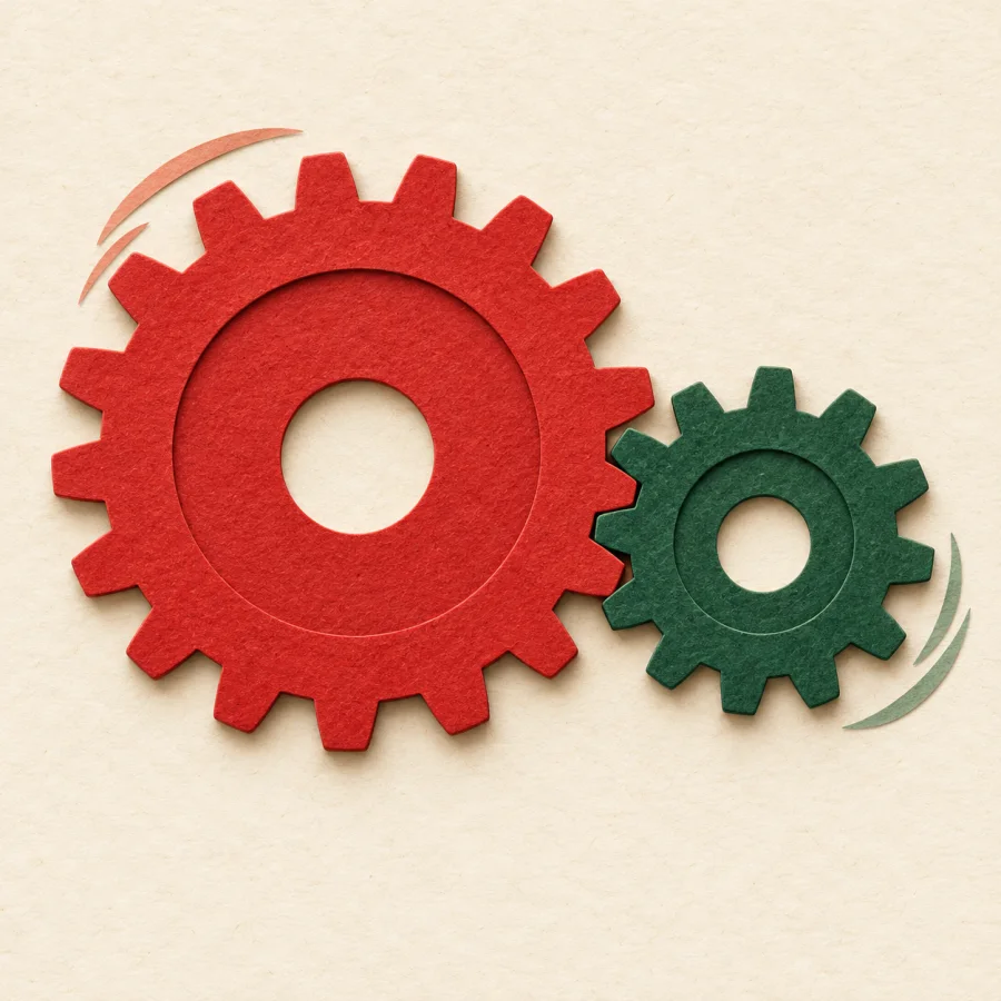 A large gear wheel turns and drives a smaller wheel beside it