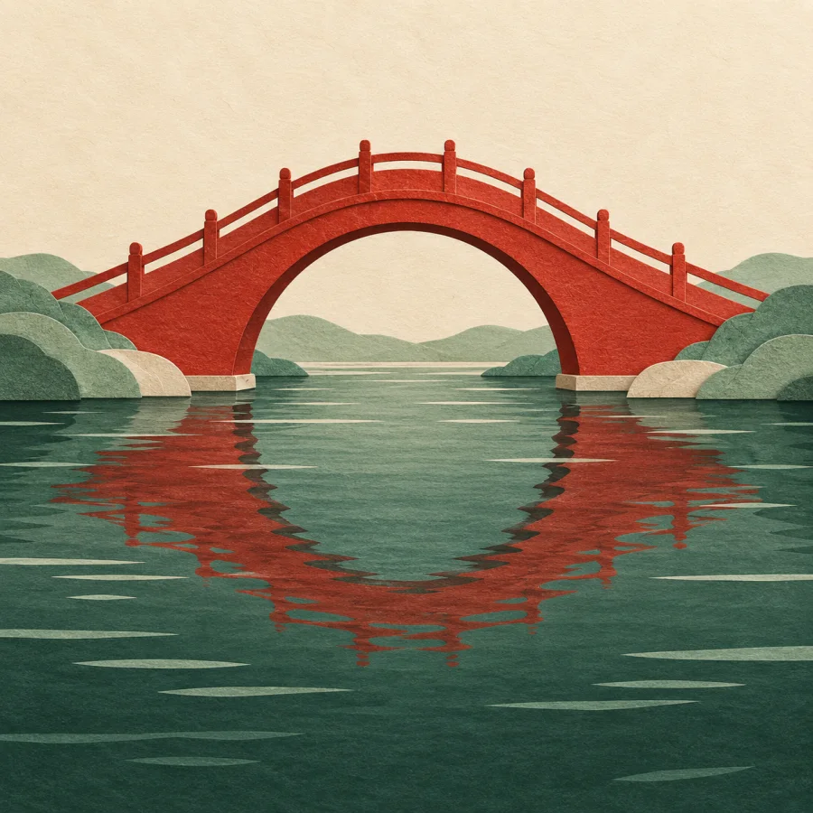 A red arched bridge with its curve mirrored in the river below