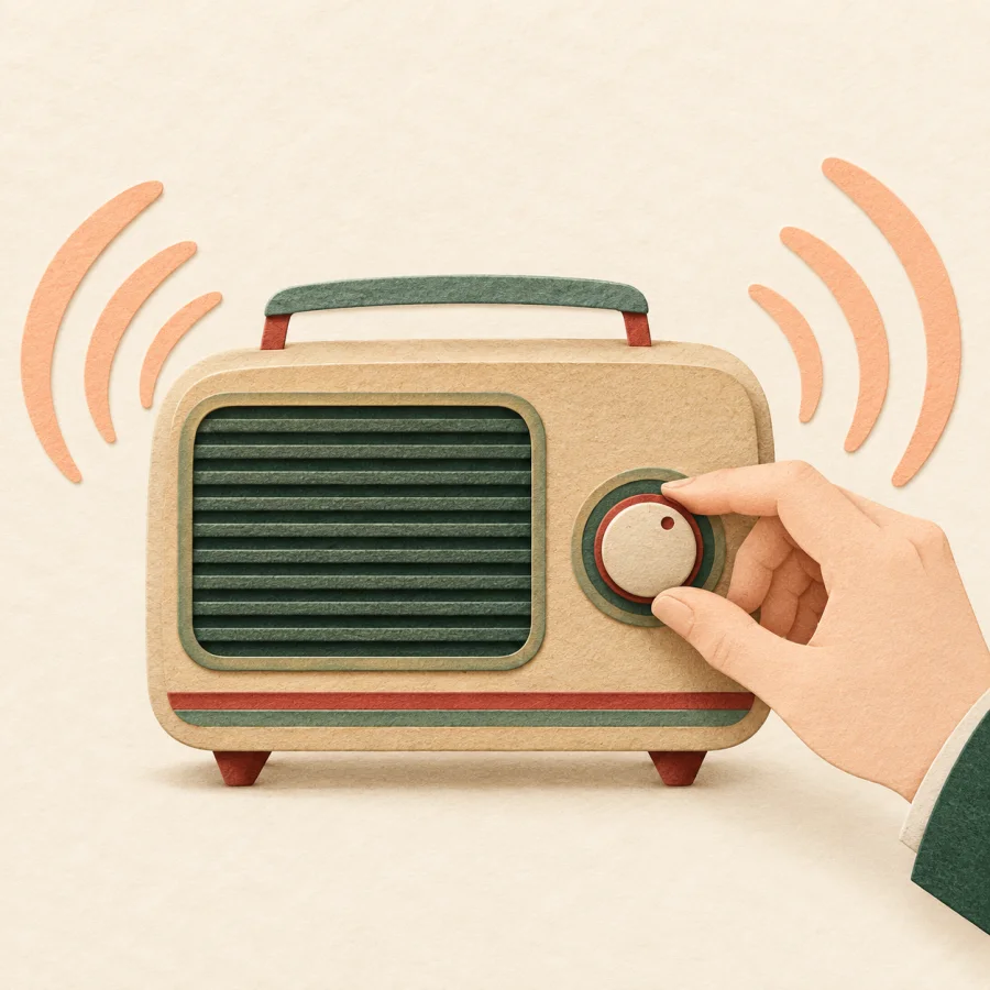A hand turns the volume knob of an old radio slightly