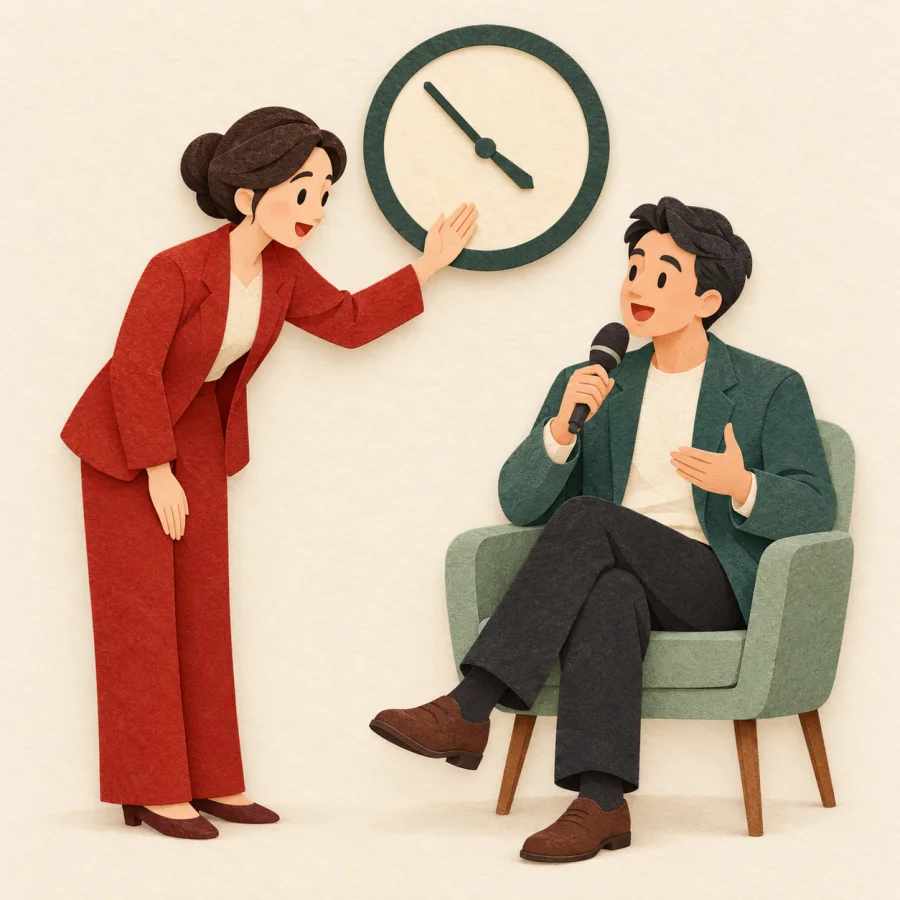 A host gestures toward a guest while glancing at a clock, urging a shorter speech